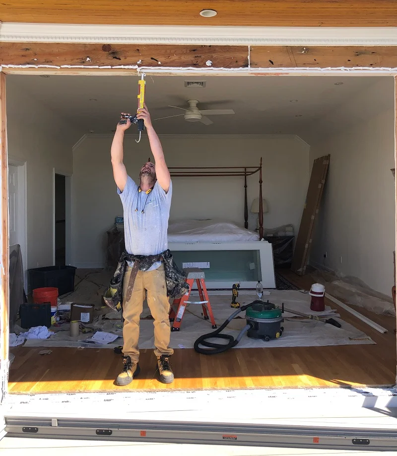 Window Solutions Plus master installer applying sealant before patio door installation